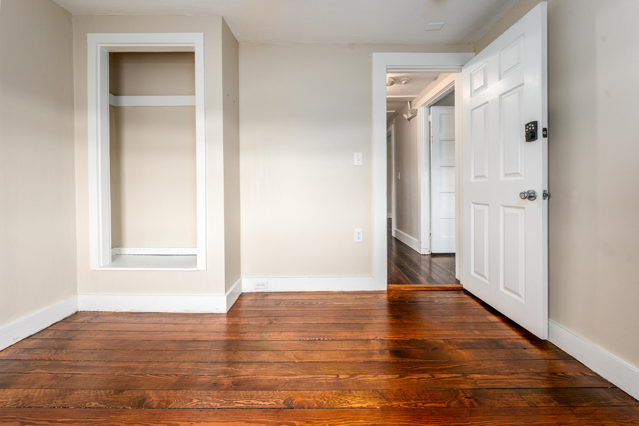 84 Bearses Way Hyannis, MA 02601 - Photo 17 of 36 a view of an empty room with wooden floor and a window