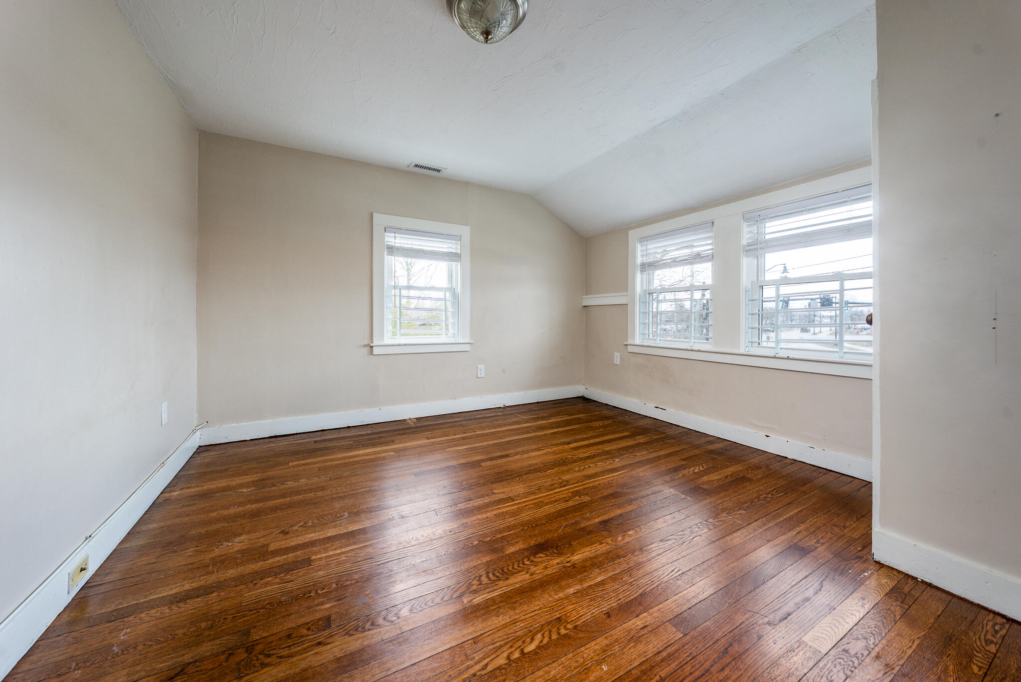 84 Bearses Way Hyannis, MA 02601 - Photo 18 of 36 an empty room with wooden floor and windows