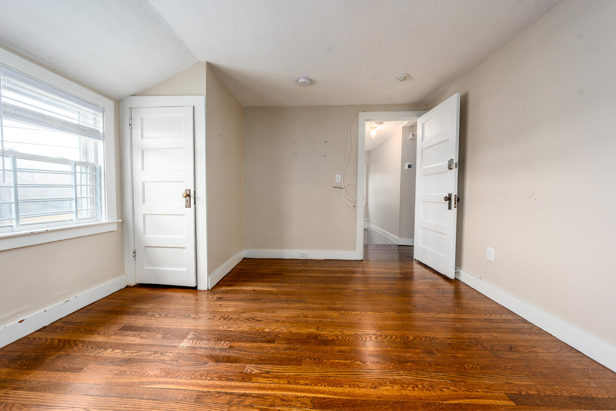 84 Bearses Way Hyannis, MA 02601 - Photo 19 of 36 a view of an empty room with wooden floor and a window