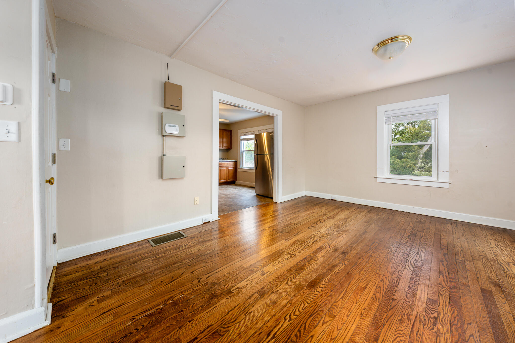 84 Bearses Way Hyannis, MA 02601 - Photo 2 of 36 an empty room with wooden floor and windows