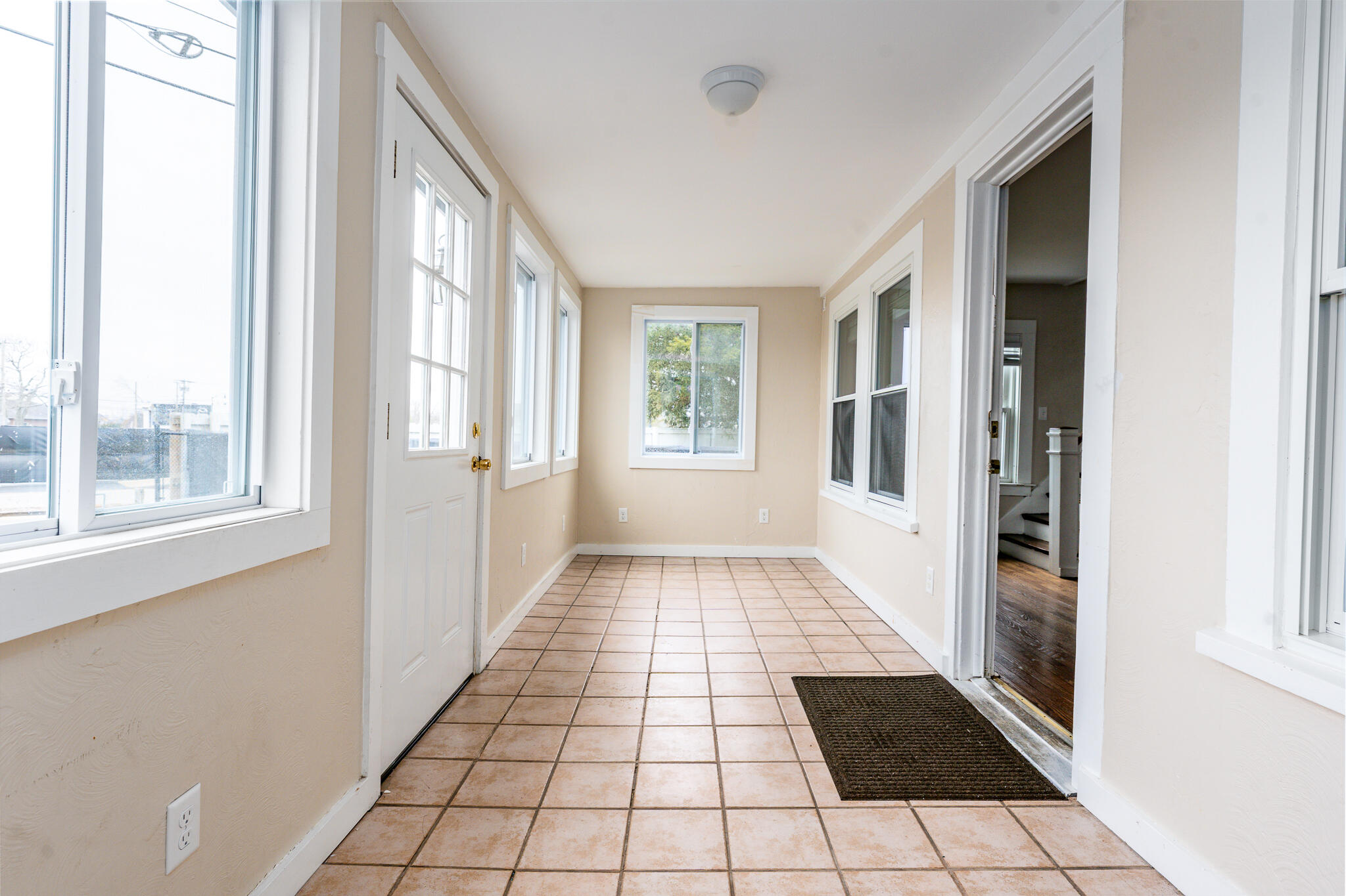 84 Bearses Way Hyannis, MA 02601 - Photo 26 of 36 a view of an entryway with wooden floor and windows