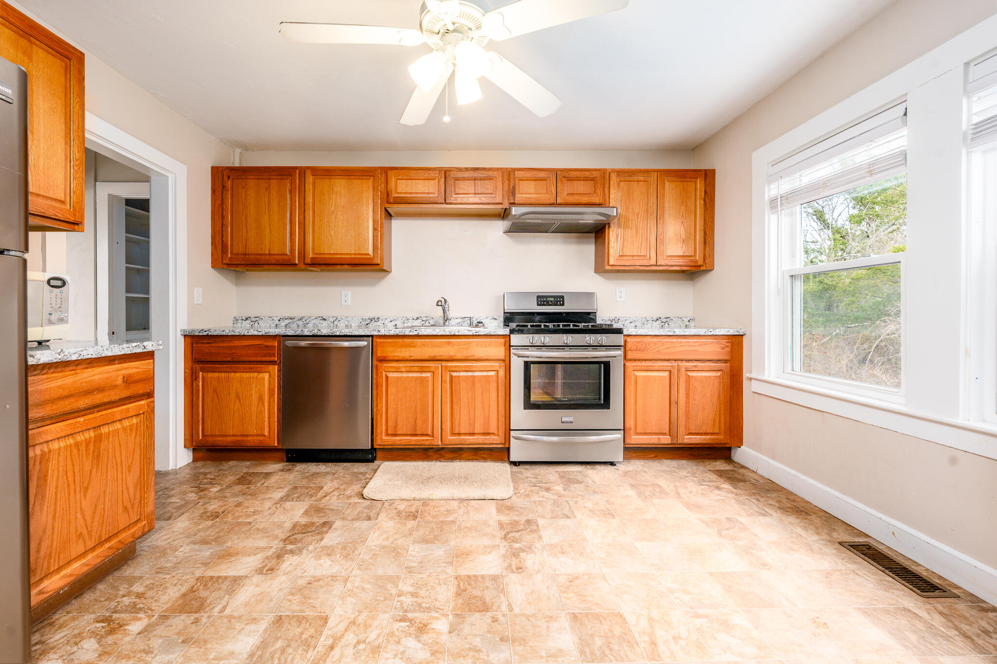 84 Bearses Way Hyannis, MA 02601 - Photo 4 of 36 a kitchen with stainless steel appliances a stove sink and cabinets