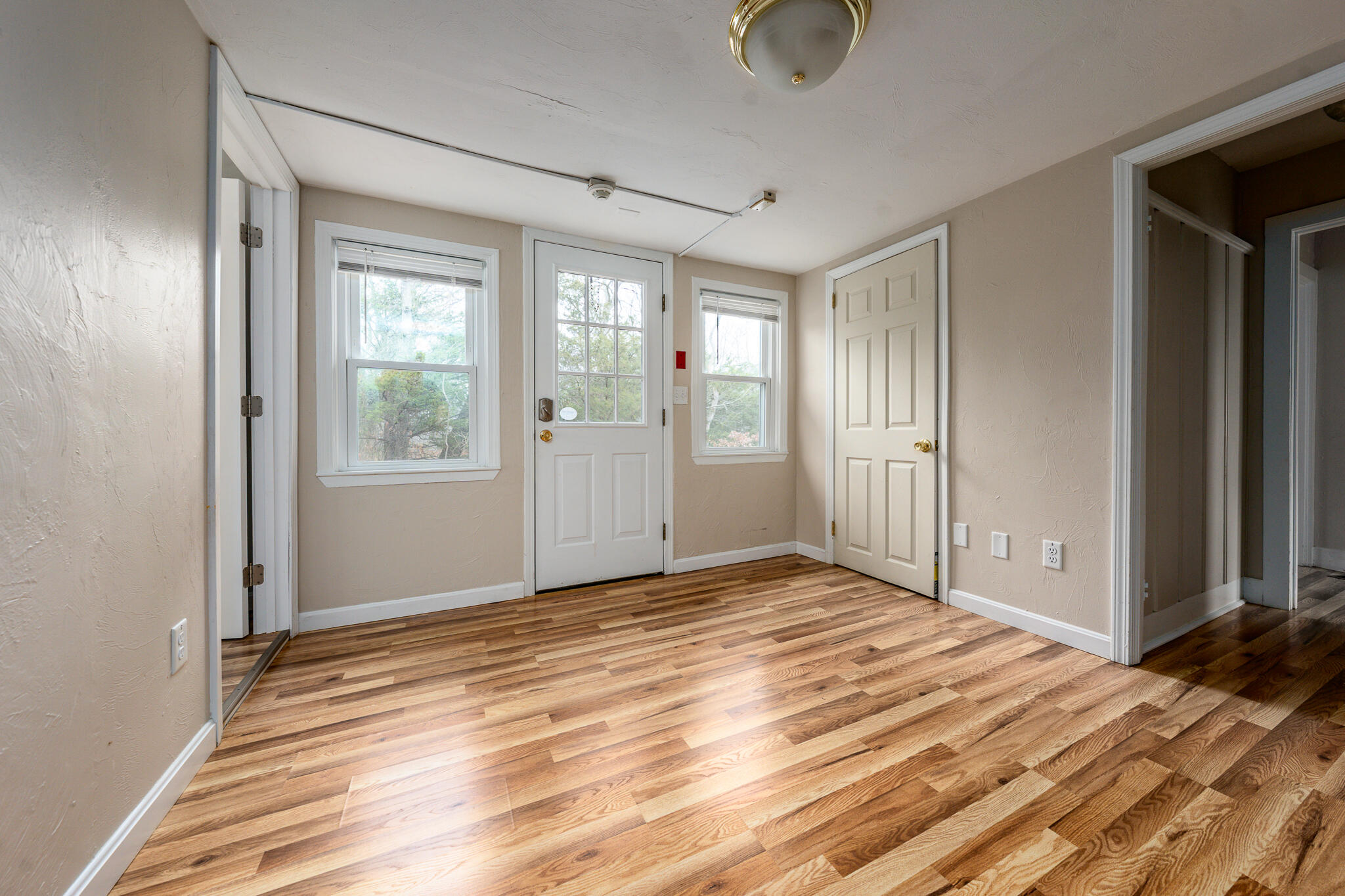 84 Bearses Way Hyannis, MA 02601 - Photo 7 of 36 a view of empty room with wooden floor and fan