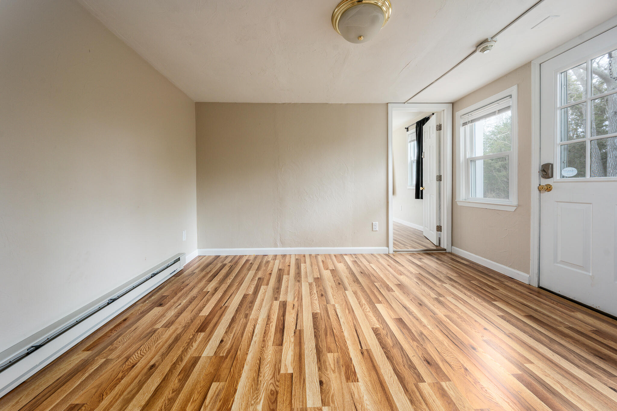 84 Bearses Way Hyannis, MA 02601 - Photo 8 of 36 a view of an empty room with wooden floor and a window