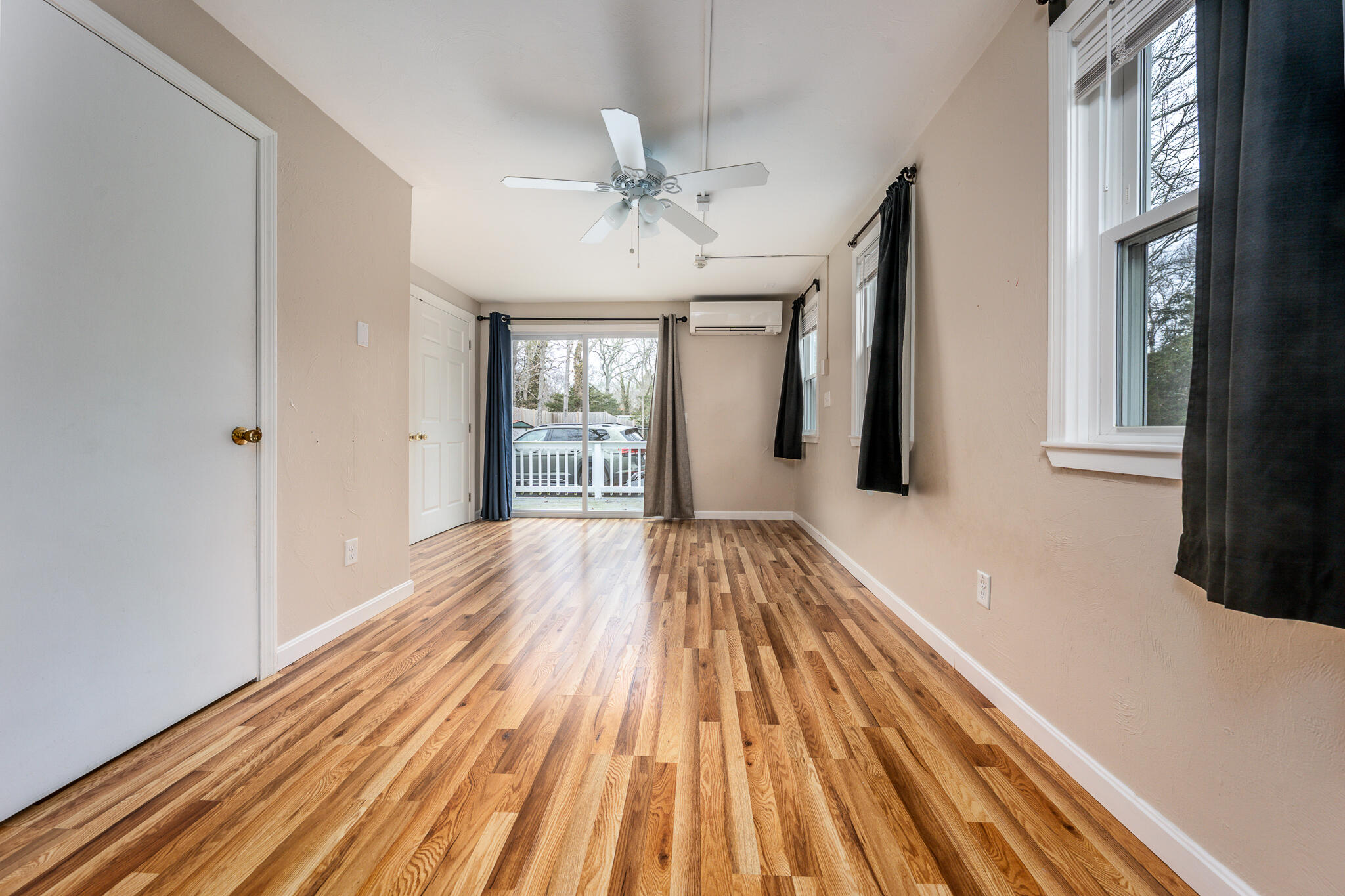 84 Bearses Way Hyannis, MA 02601 - Photo 10 of 36 wooden floor in an empty room with a window