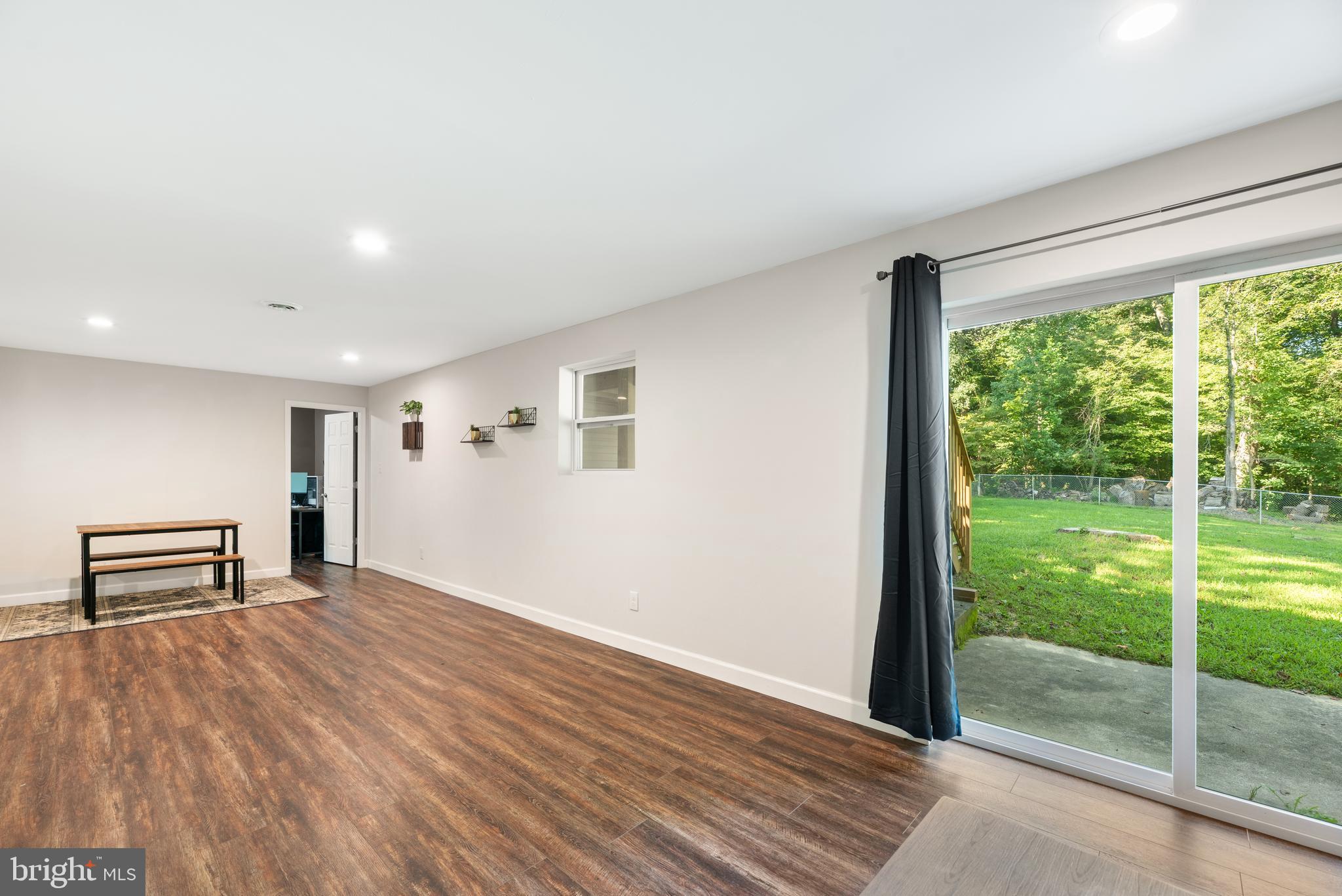5756 Stephen Reid Road Huntingtown, MD 20639 - Photo 34 of 42 a view of empty room with wooden floor and fan