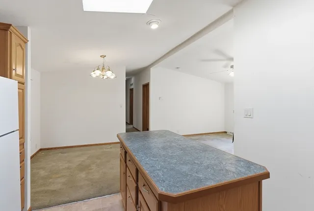 an empty room with kitchen view