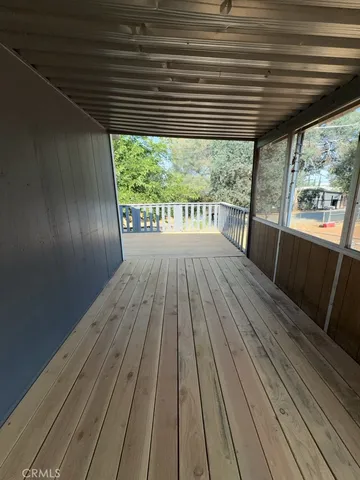 a view of balcony with wooden floor