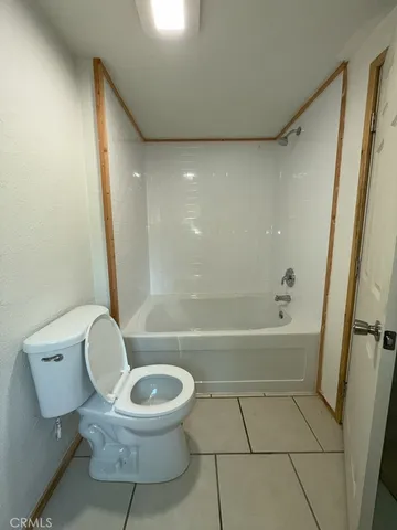 a bathroom with a toilet and a bathtub