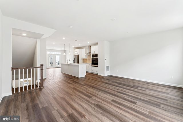 a view of a kitchen with wooden floor and a kitchen
