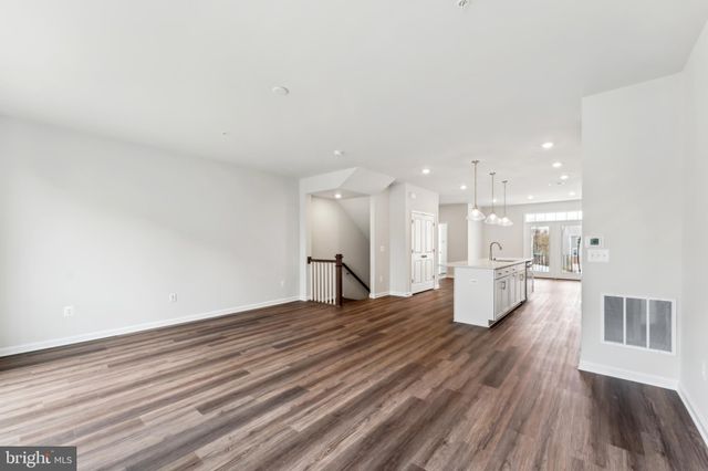 a view of a kitchen with a sink and a wooden floor