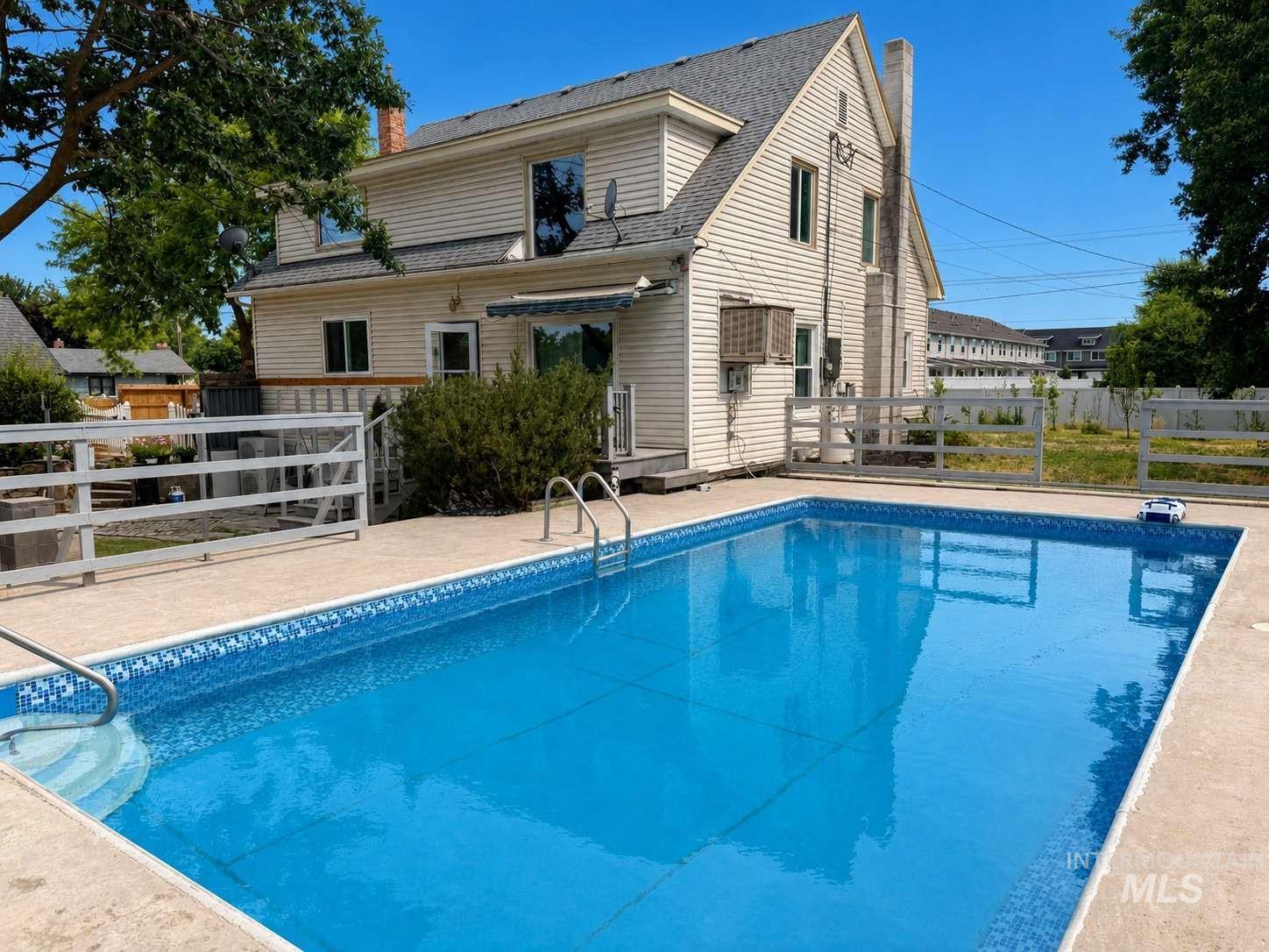 1158 South Powerline Road Nampa, ID 83686 - Photo 2 of 46 In-ground swimming pool featuring a patterned liner and concrete surround
