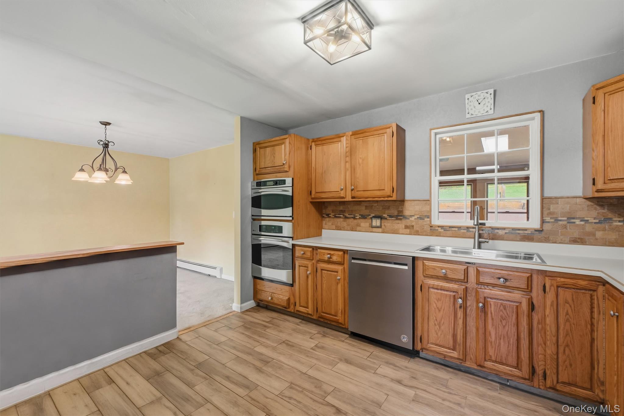 17 Ridge Road Cortlandt Manor, NY 10567 - Photo 12 of 38 SS appliances, double wall oven, kitchen opens to both Livingroom & dining area