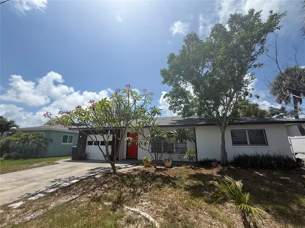 a view of a house with a yard and garage