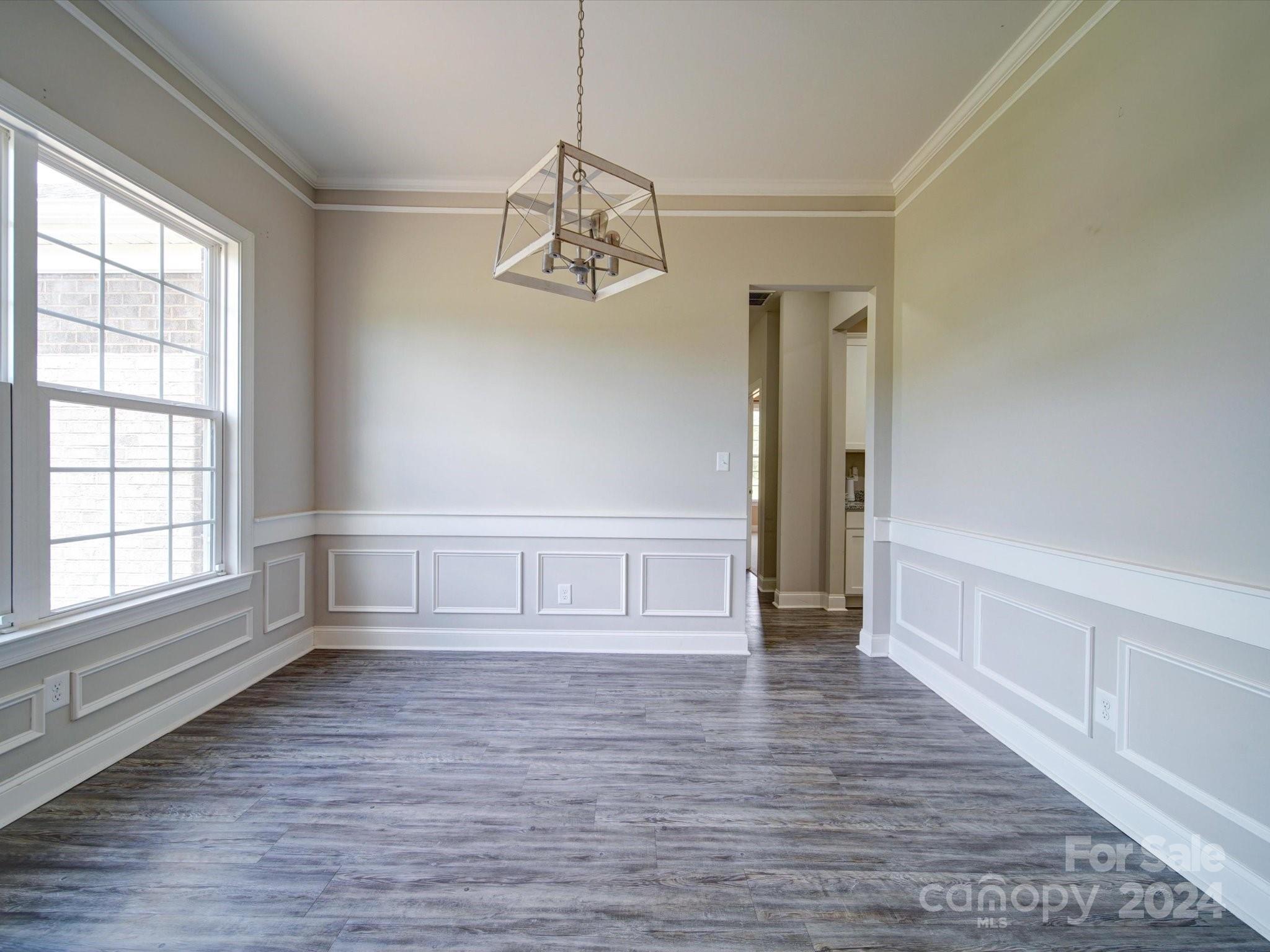 962 Miles Road Dallas, NC 28034 - Photo 4 of 35 a view of empty room with wooden floor and window