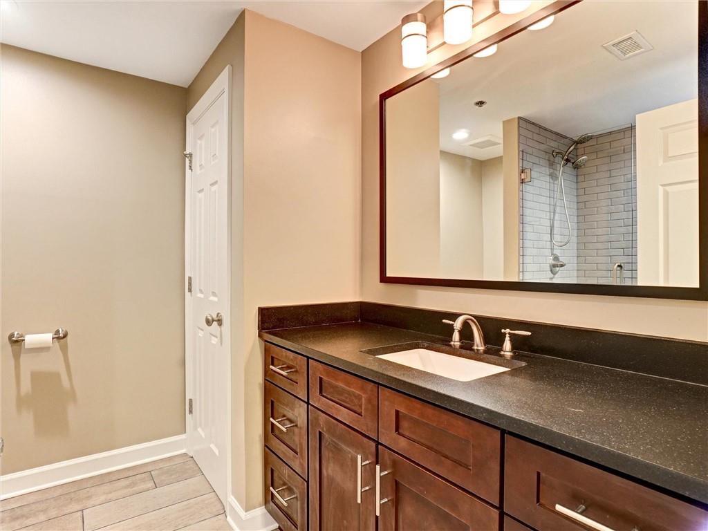 3435 Kingsboro Road Northeast, Unit 1601 Atlanta, GA 30326 - Photo 29 of 54 a bathroom with a sink and a mirror