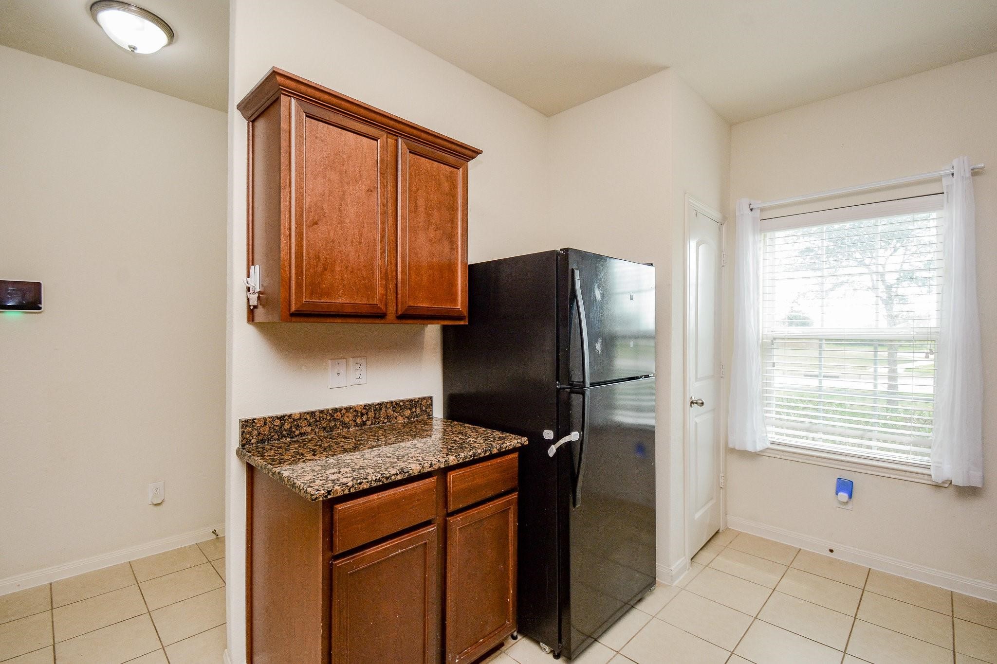 1322 Emerald Stone Drive Rosharon, TX 77583 - Photo 5 of 23 a kitchen with stainless steel appliances granite countertop a refrigerator and a stove top oven