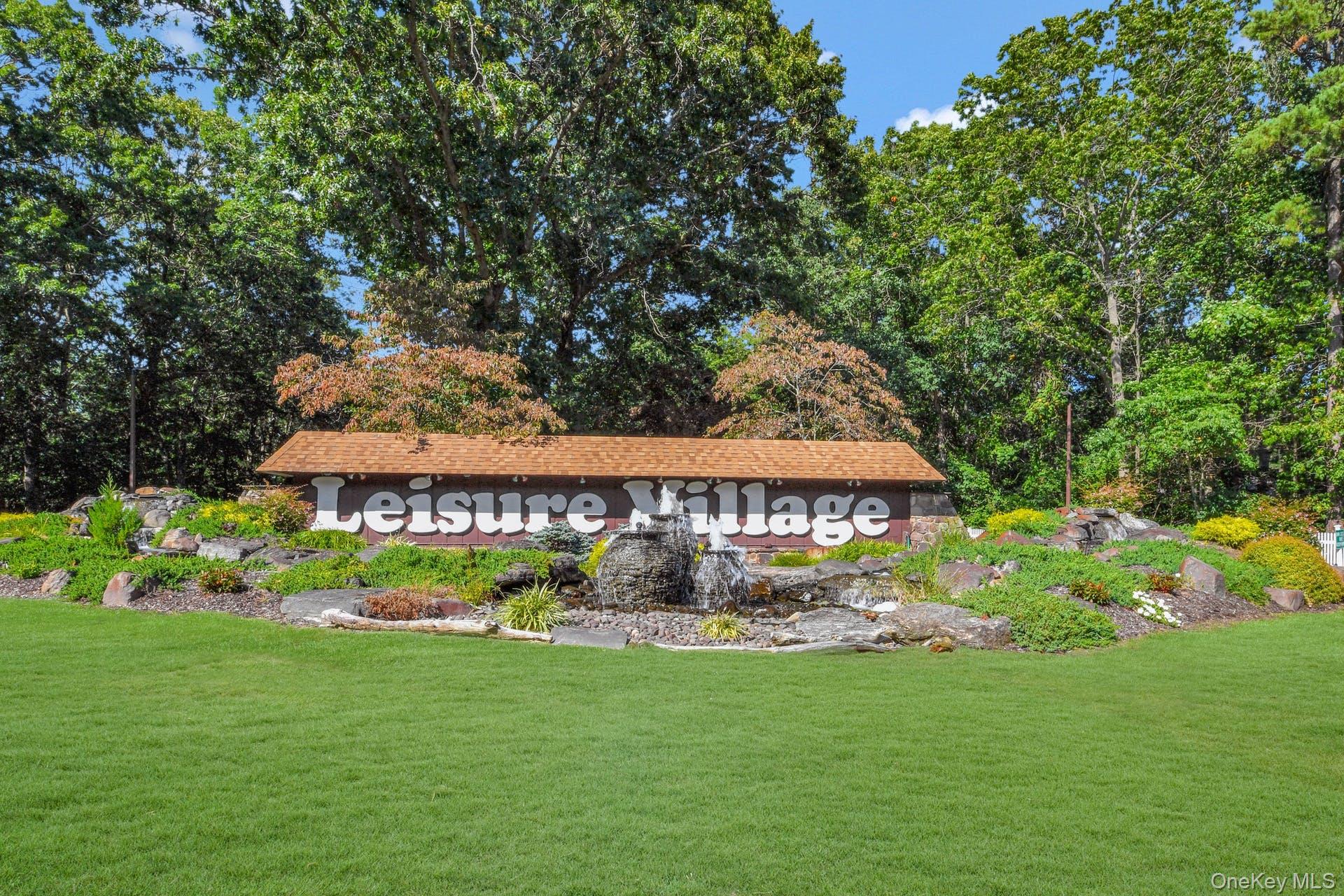 405 Woodbridge Drive, Unit D Ridge, NY 11961 - Photo 12 of 13 a view of a sign in the garden