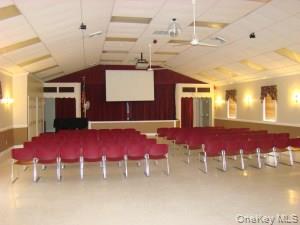 405 Woodbridge Drive, Unit D Ridge, NY 11961 - Photo 13 of 13 a view of a dining room with furniture and chandelier