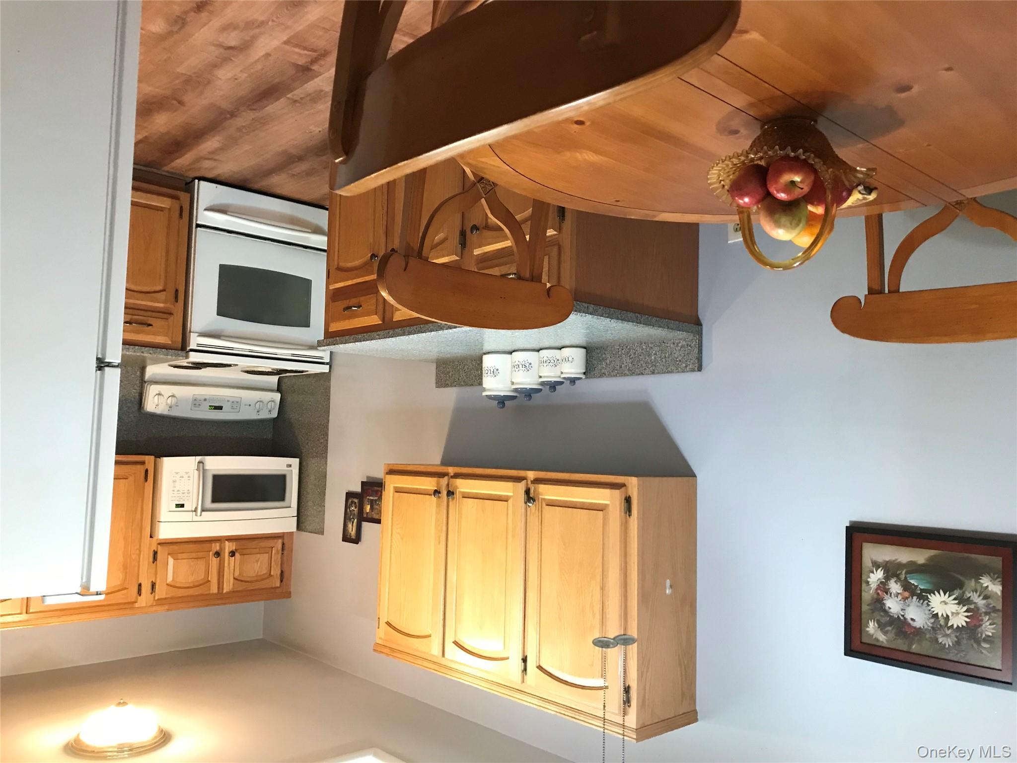 405 Woodbridge Drive, Unit D Ridge, NY 11961 - Photo 2 of 13 a bedroom with furniture and a window