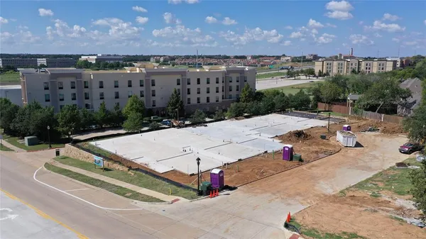 an aerial view of residential houses with yard