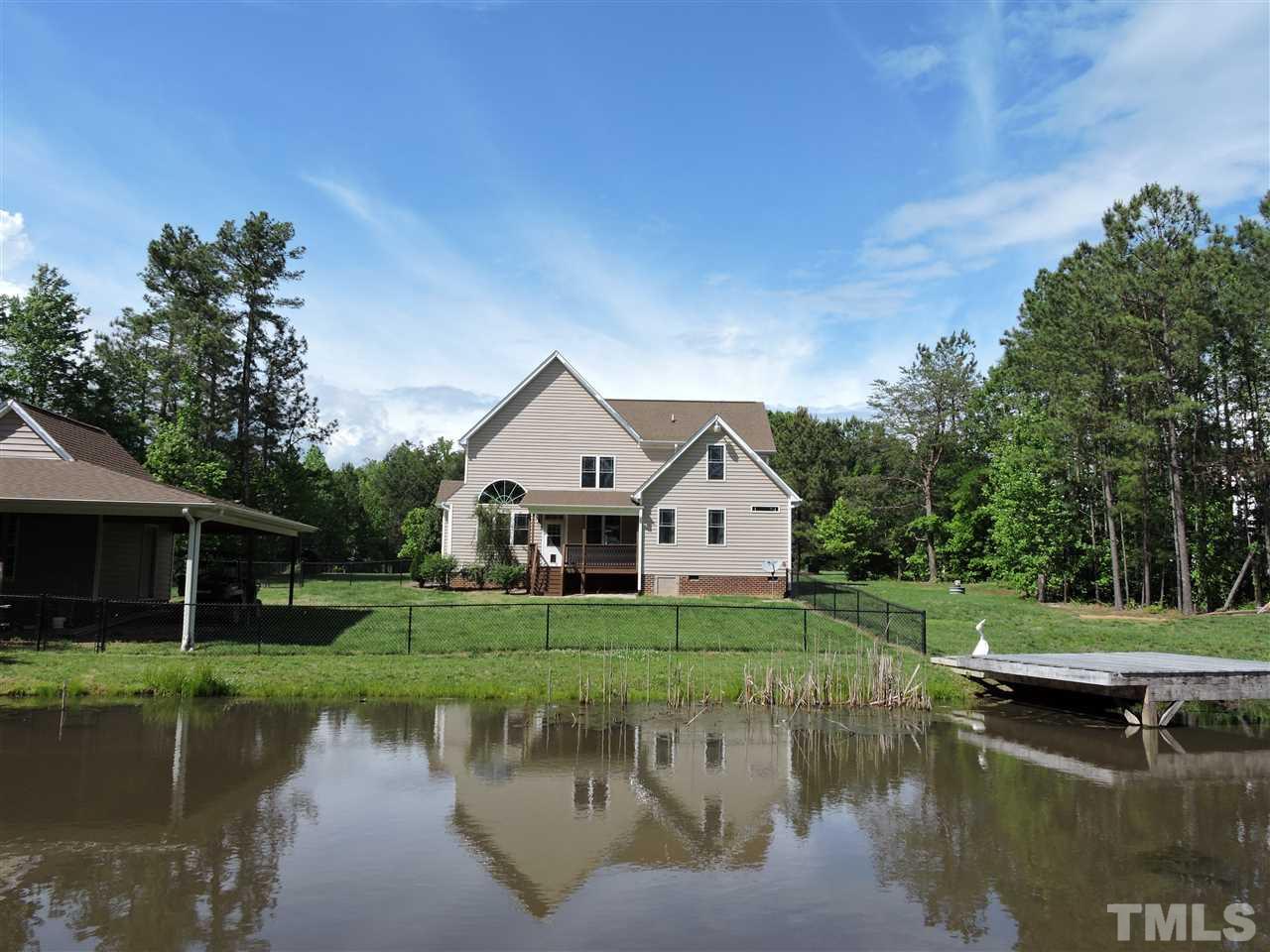 223 Fletcher Ridge Road Timberlake, NC 27583 - Photo 2 of 24 a view of a house with a yard from a lake view