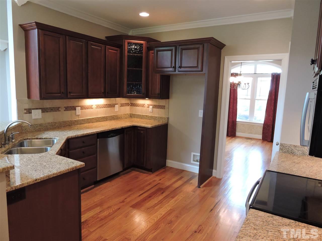 223 Fletcher Ridge Road Timberlake, NC 27583 - Photo 12 of 24 a kitchen with stainless steel appliances granite countertop a refrigerator a sink and a stove