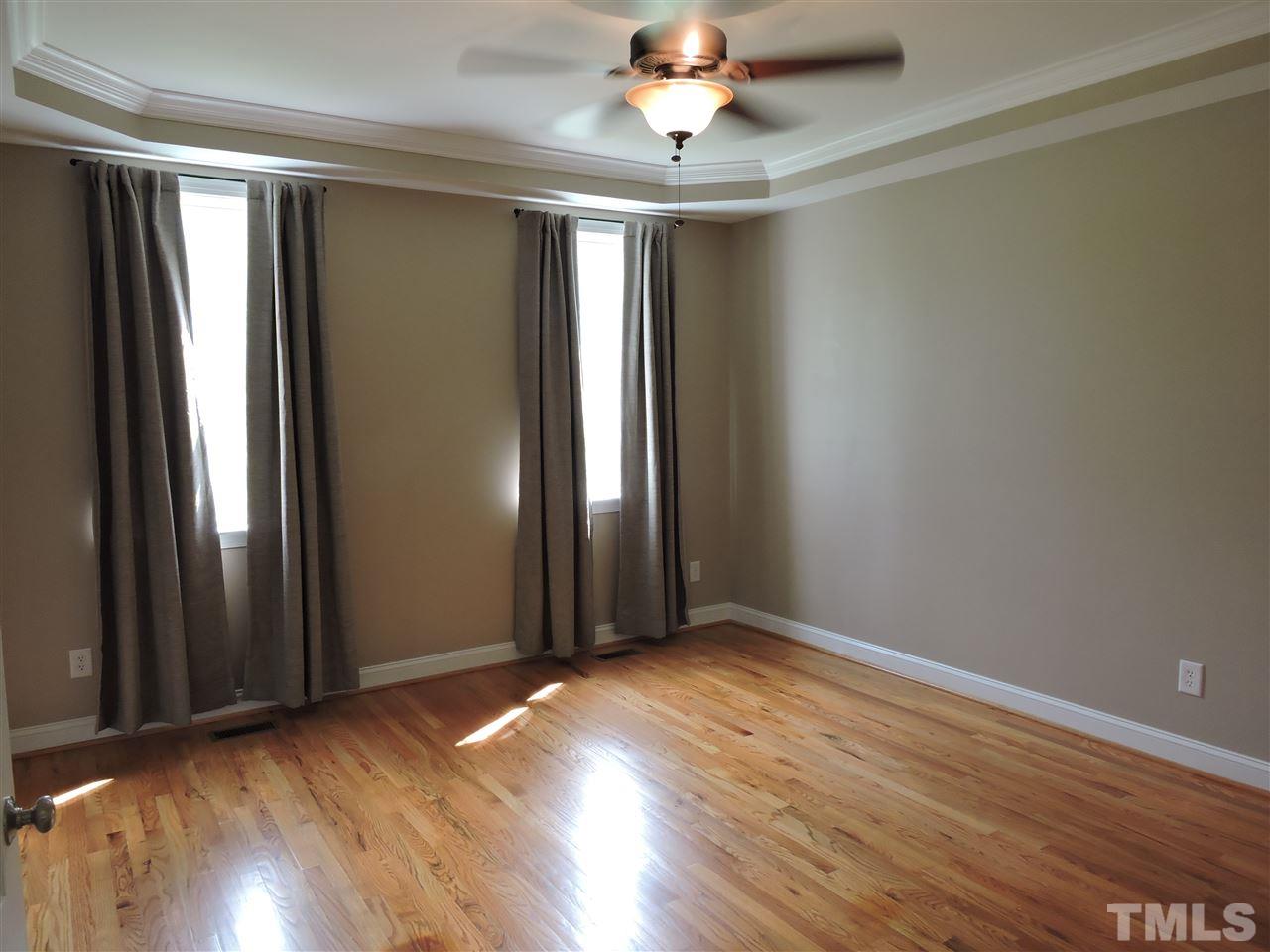 223 Fletcher Ridge Road Timberlake, NC 27583 - Photo 14 of 24 an empty room with wooden floor and windows