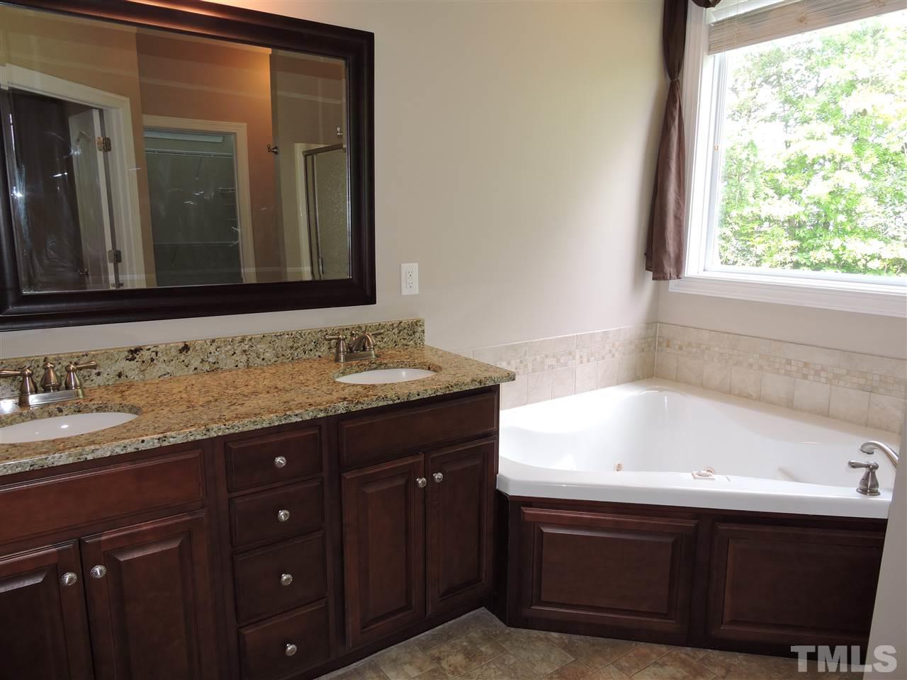 223 Fletcher Ridge Road Timberlake, NC 27583 - Photo 15 of 24 a bathroom with a sink and a bathtub