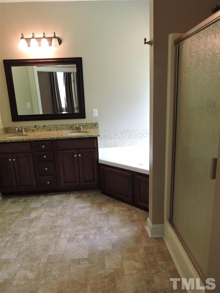 223 Fletcher Ridge Road Timberlake, NC 27583 - Photo 16 of 24 a room with a dresser and a mirror