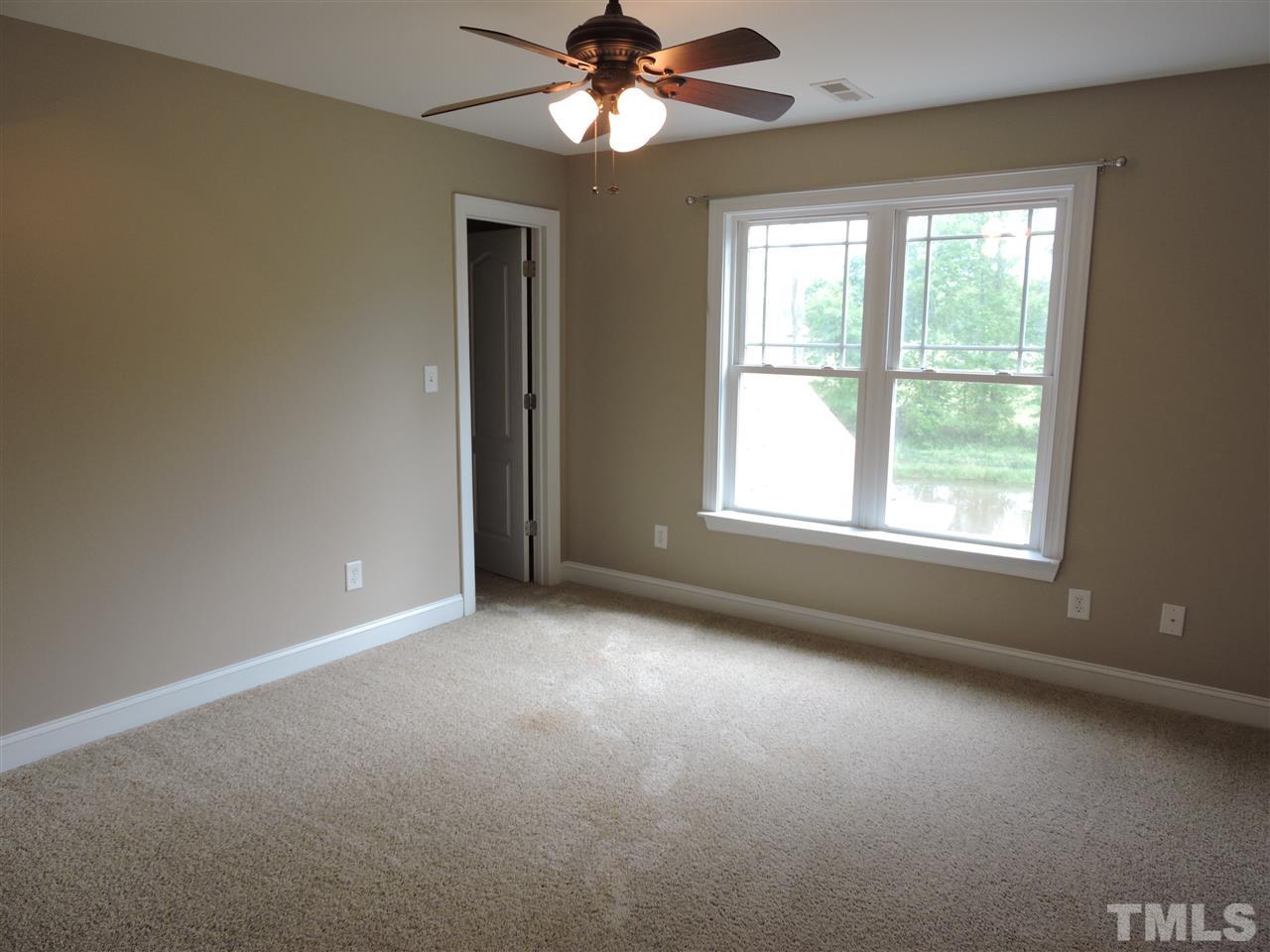 223 Fletcher Ridge Road Timberlake, NC 27583 - Photo 19 of 24 an empty room with a window and a fan