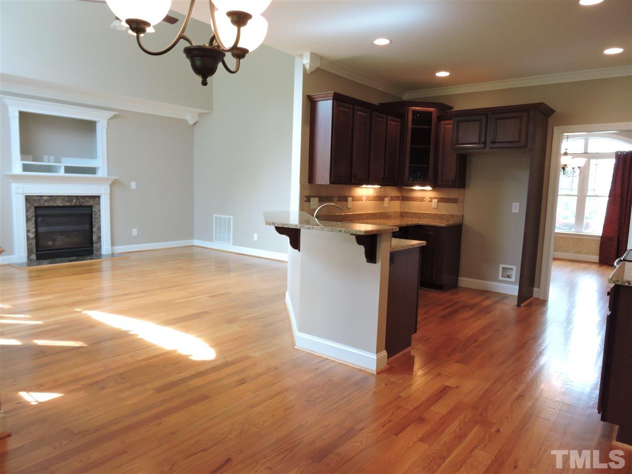 223 Fletcher Ridge Road Timberlake, NC 27583 - Photo 3 of 24 a view of a kitchen with a sink and a fireplace
