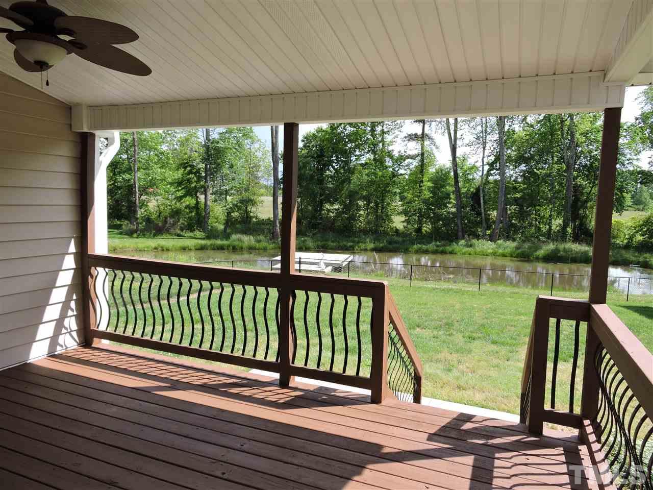 223 Fletcher Ridge Road Timberlake, NC 27583 - Photo 22 of 24 a view of a balcony with floor to ceiling windows with wooden floor