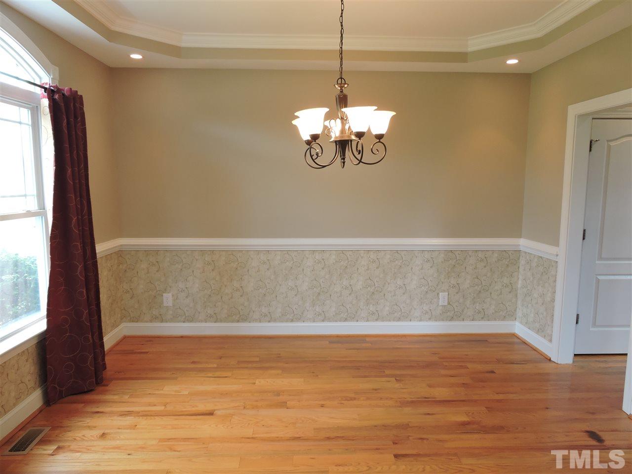 223 Fletcher Ridge Road Timberlake, NC 27583 - Photo 5 of 24 a view of a livingroom with a chandelier wooden floor and windows