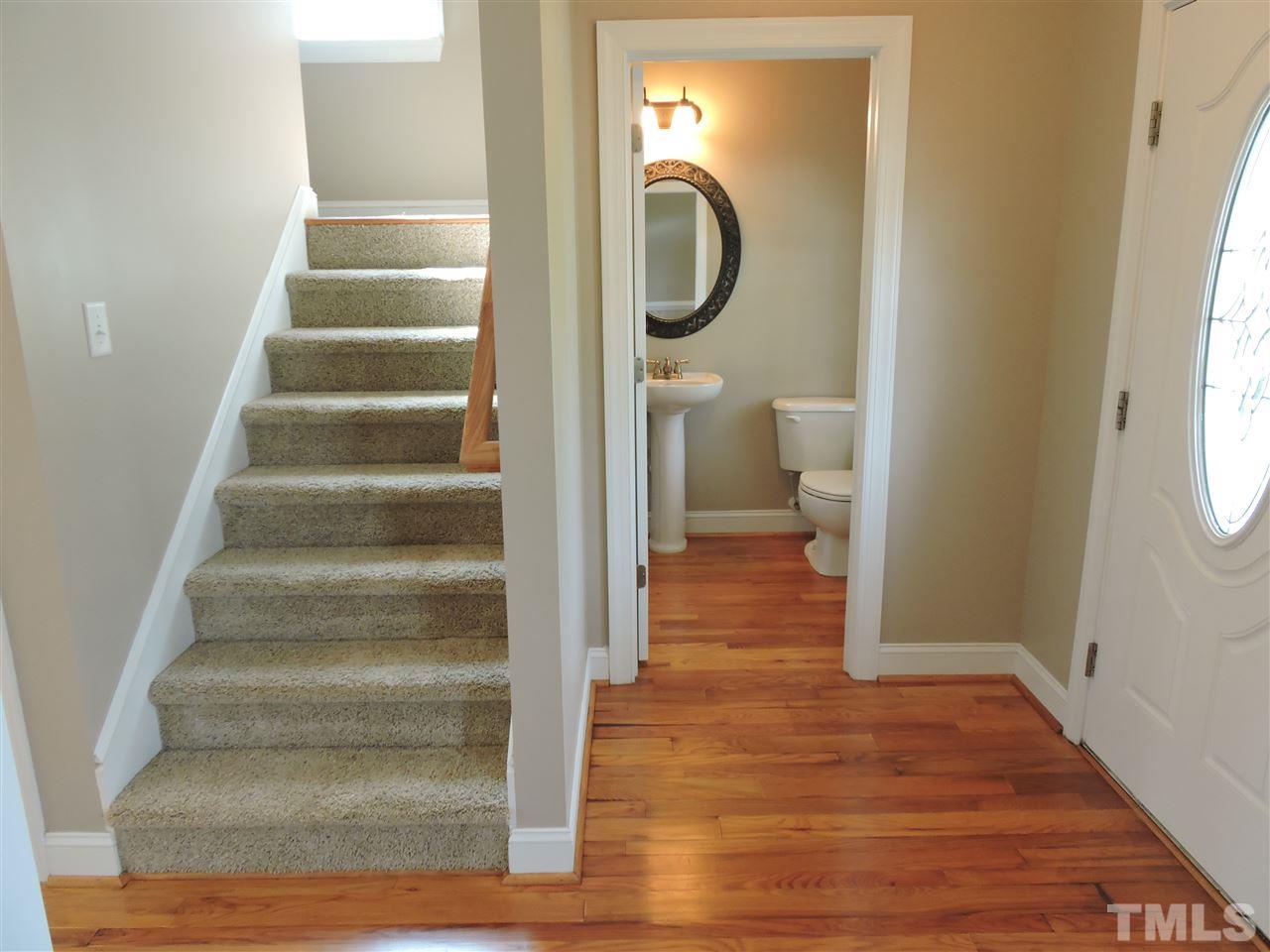 223 Fletcher Ridge Road Timberlake, NC 27583 - Photo 10 of 24 a view of a hallway with wooden floor and staircase
