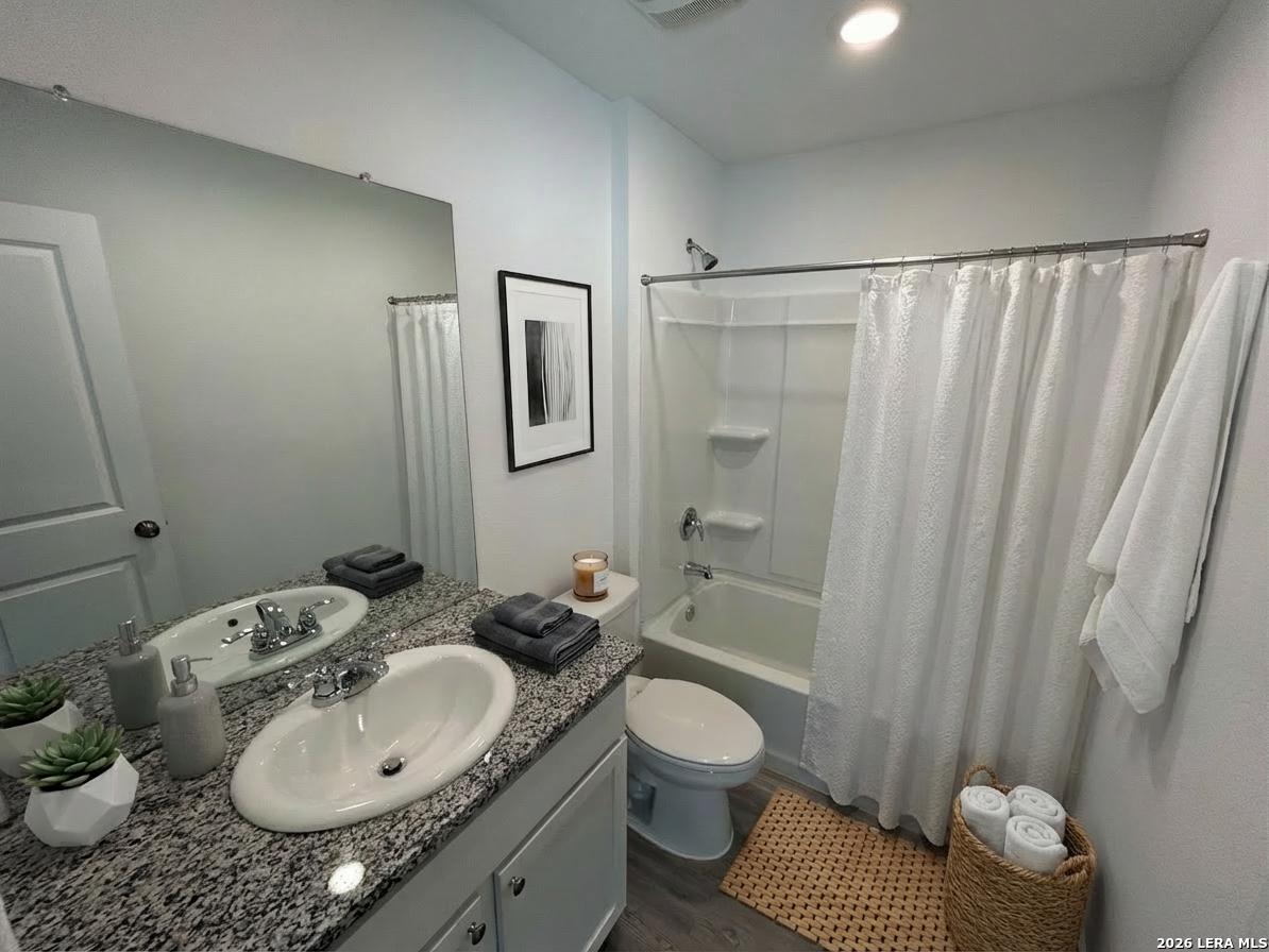 11026 Tree Line San Antonio, TX 78223 - Photo 15 of 31 a bathroom with a granite countertop sink toilet and shower