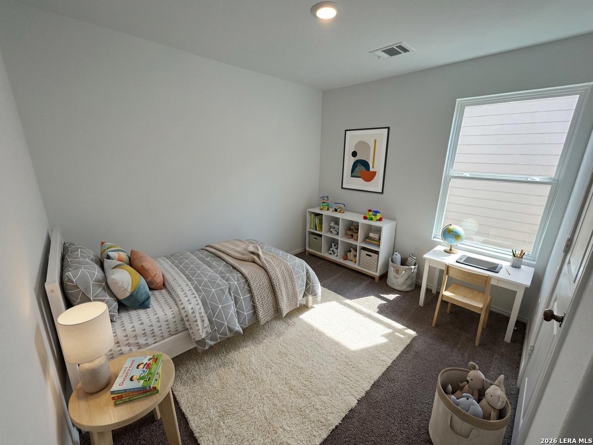 11026 Tree Line San Antonio, TX 78223 - Photo 17 of 31 a bedroom with a bed and a chair