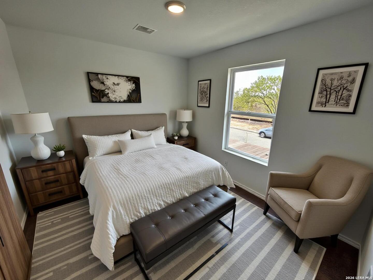 11026 Tree Line San Antonio, TX 78223 - Photo 20 of 31 a bedroom with a bed and wooden floor