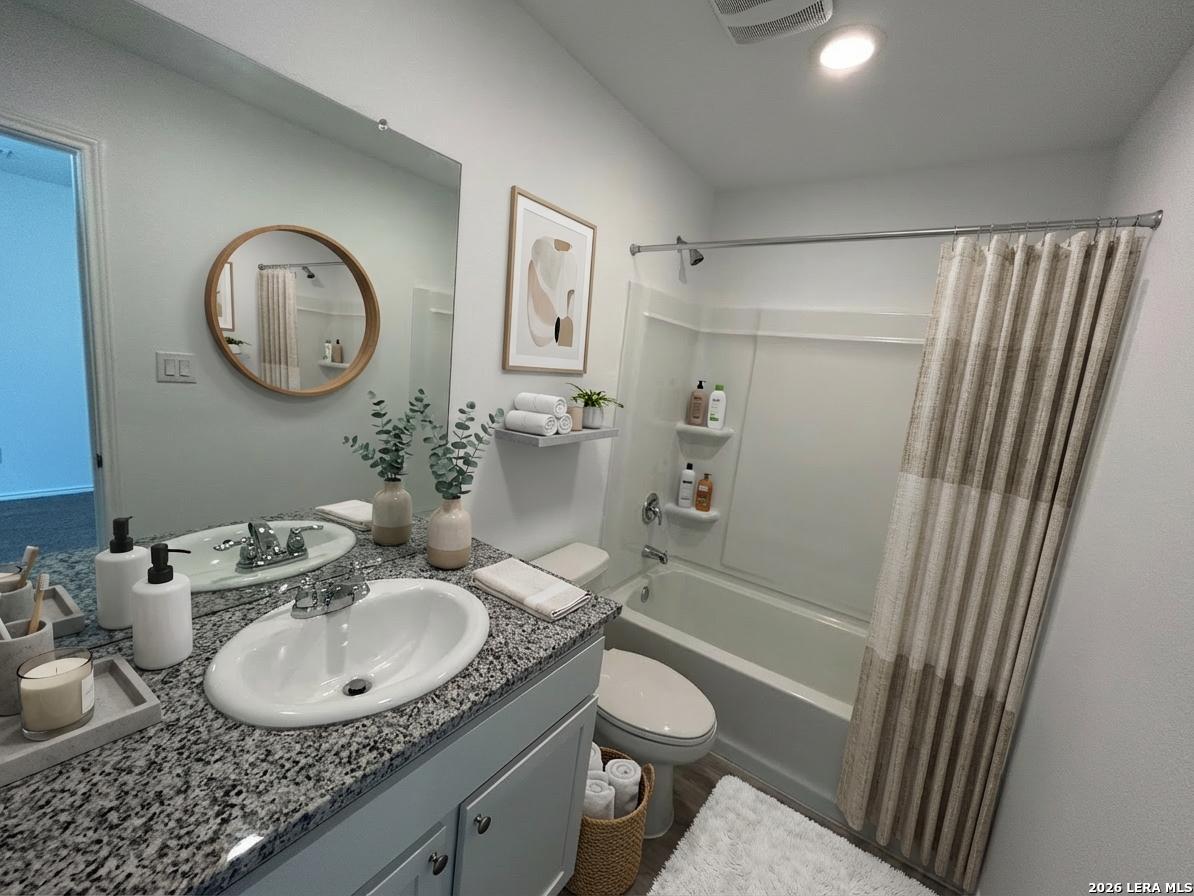 11026 Tree Line San Antonio, TX 78223 - Photo 26 of 31 a bathroom with a granite countertop sink toilet a mirror and shower