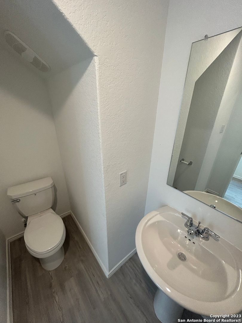 11026 Tree Line San Antonio, TX 78223 - Photo 4 of 31 a bathroom with a toilet and a sink