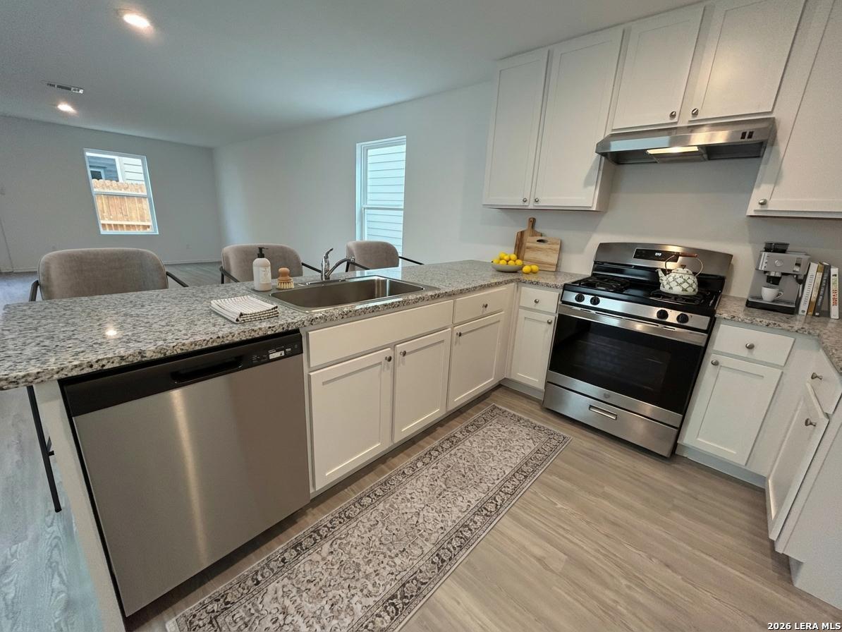 11026 Tree Line San Antonio, TX 78223 - Photo 7 of 31 a kitchen with stainless steel appliances granite countertop a sink stove and cabinets