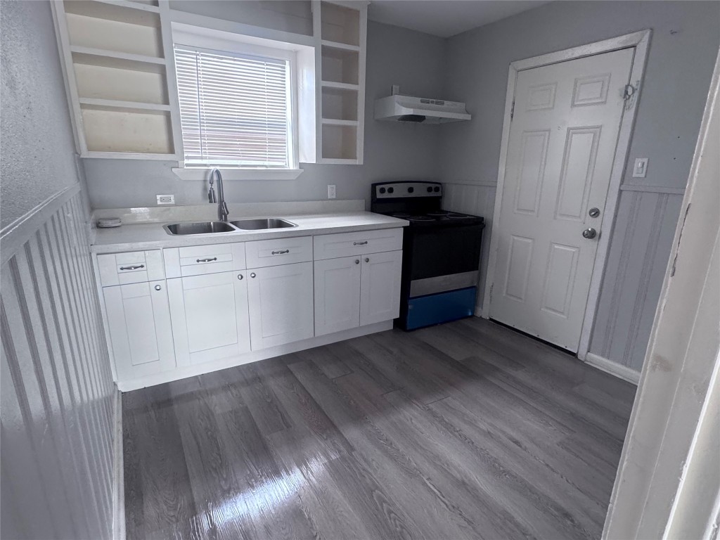 1306 Weiss Street Houston, TX 77009 - Photo 9 of 10 a kitchen with granite countertop white cabinets and white appliances