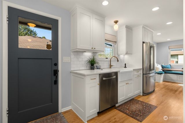 a kitchen with a sink appliances and cabinets
