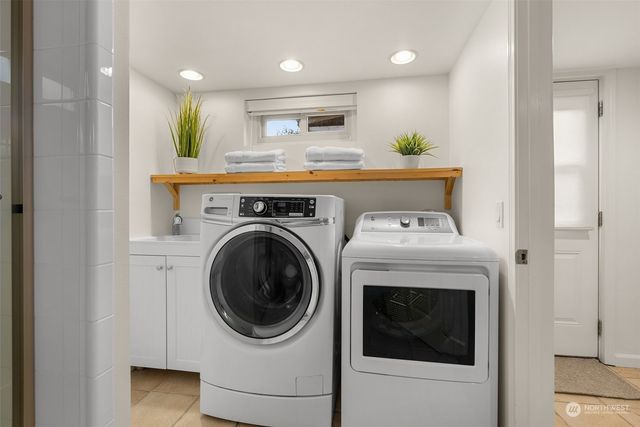 a view of a hallway with washer and dryer