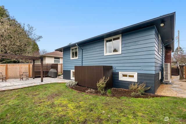 a backyard of a house with yard and outdoor seating