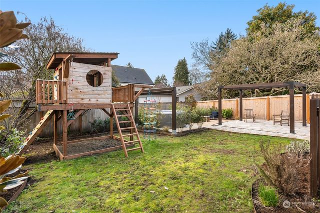 a view of a house with backyard and sitting area