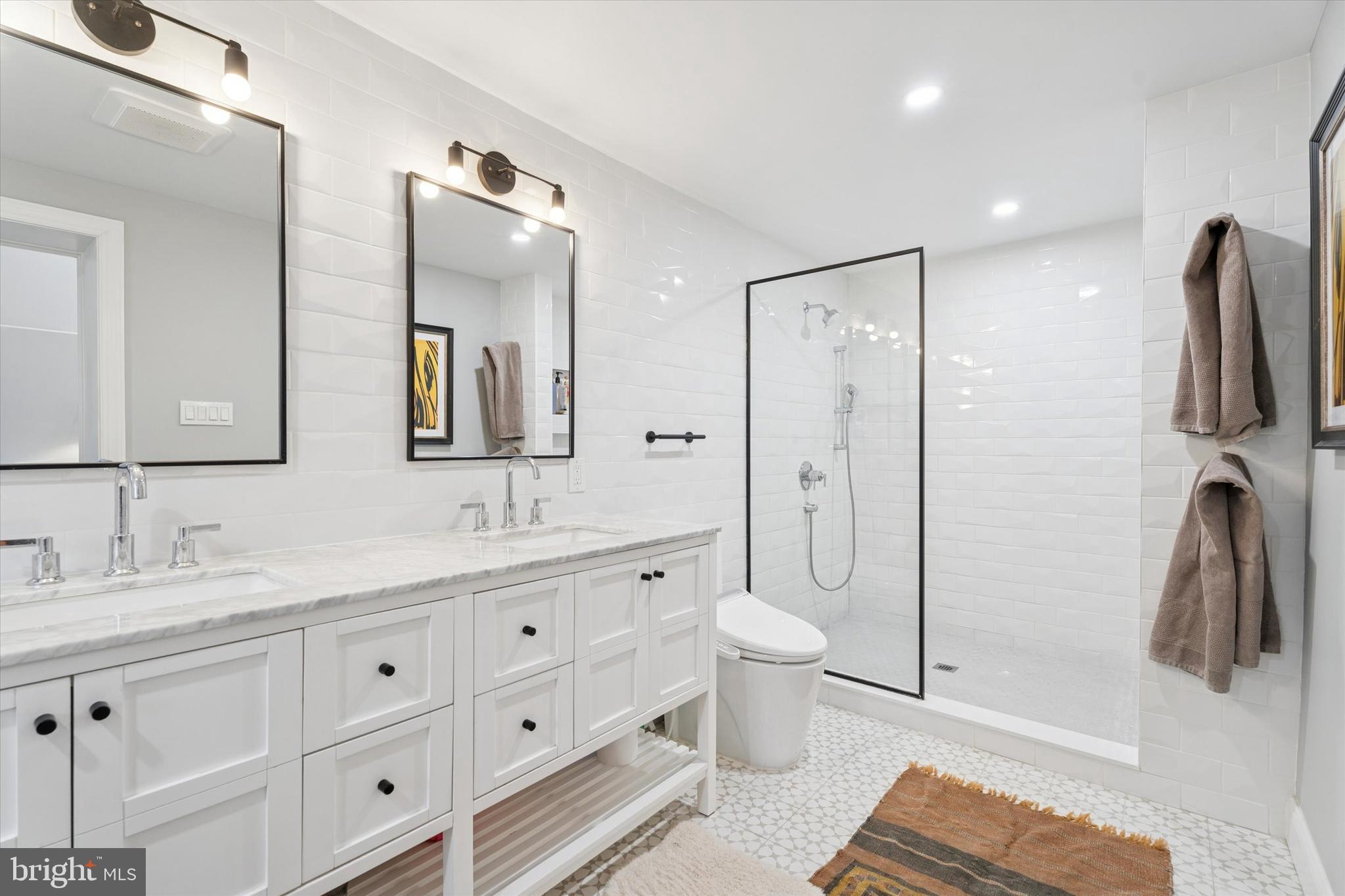 603 Old Gulph Road Penn Valley, PA 19072 - Photo 14 of 58 a bathroom with a double vanity sink toilet and shower