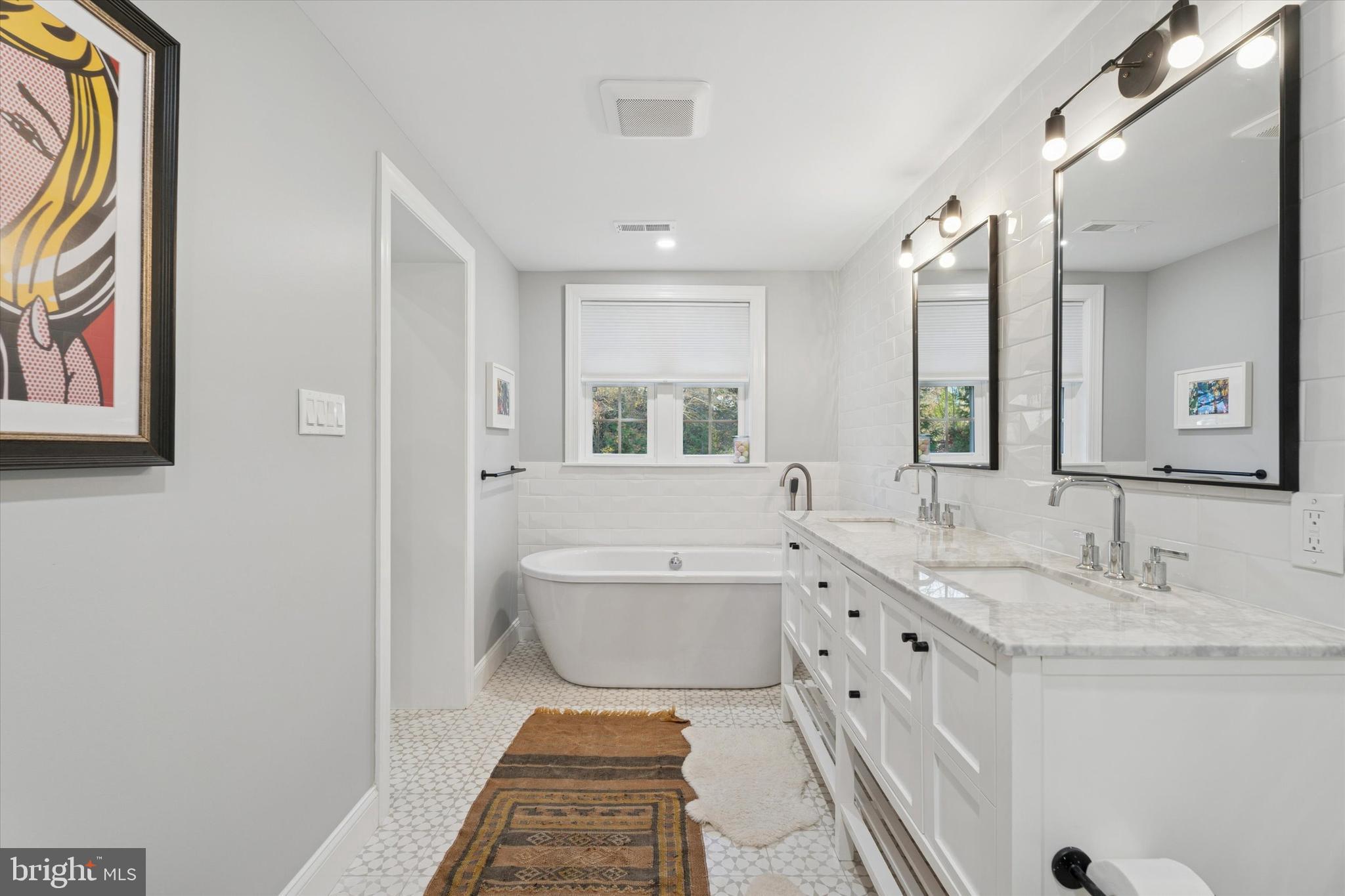 603 Old Gulph Road Penn Valley, PA 19072 - Photo 15 of 58 a spacious bathroom with a double vanity sink mirror and a bathtub