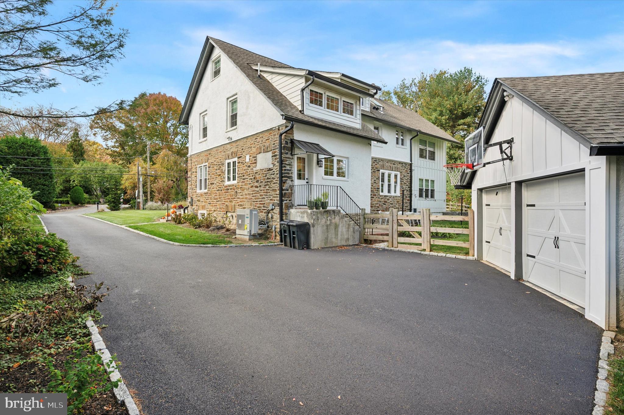 603 Old Gulph Road Penn Valley, PA 19072 - Photo 42 of 58 a front view of a house with a yard and garage