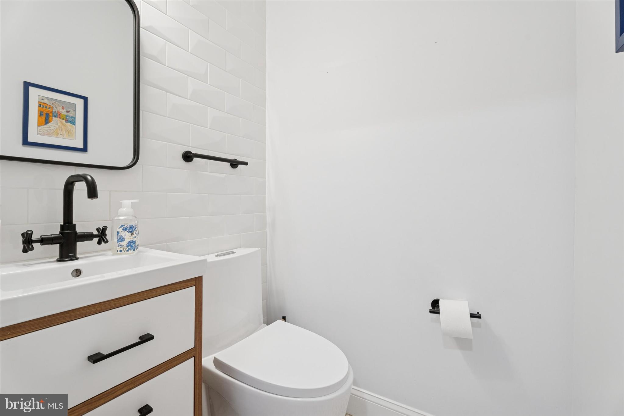 603 Old Gulph Road Penn Valley, PA 19072 - Photo 10 of 58 a bathroom with a toilet sink and mirror